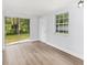 Bright room with sliding glass doors and view of the back yard and light wood laminate flooring at 14761 Sw 35Th Terrace Rd, Ocala, FL 34473