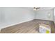 A spacious living room with a ceiling fan and a door to the outside and light wood laminate flooring at 14761 Sw 35Th Terrace Rd, Ocala, FL 34473