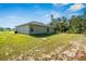 Expansive backyard featuring lush green grass and a home exterior with a well-maintained lawn at 15212 Sw 27Th Ct, Ocala, FL 34473