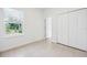 Inviting bedroom with a window, closet, and access to other rooms, creating an open flow at 15212 Sw 27Th Ct, Ocala, FL 34473