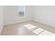 Bright bedroom featuring a large window, natural light and neutral-toned tile floors at 15212 Sw 27Th Ct, Ocala, FL 34473