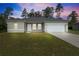 Charming single-story home featuring a well-manicured lawn and an attached two-car garage at 15212 Sw 27Th Ct, Ocala, FL 34473