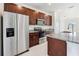 Close up of kitchen featuring stainless steel appliances, granite countertops, and dark wood cabinetry at 15212 Sw 27Th Ct, Ocala, FL 34473