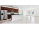 Open-concept kitchen featuring stainless steel appliances, granite countertops, and dark wood cabinetry at 15212 Sw 27Th Ct, Ocala, FL 34473