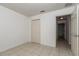 A tiled bedroom featuring an open door and a closet at 15711 Sw 52Nd Avenue Rd, Ocala, FL 34473
