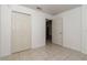 A tiled bedroom featuring an open door and a closet at 15711 Sw 52Nd Avenue Rd, Ocala, FL 34473