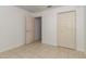 A tiled bedroom featuring an open door and a closet at 15711 Sw 52Nd Avenue Rd, Ocala, FL 34473