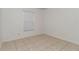 A tiled bedroom with natural light coming in through the window at 15711 Sw 52Nd Avenue Rd, Ocala, FL 34473