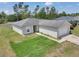 Exterior view of a charming single story home with a well-manicured lawn and an attached two-car garage at 15711 Sw 52Nd Avenue Rd, Ocala, FL 34473