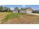 View of the home's exterior showcasing the attached garage and the front yard at 15711 Sw 52Nd Avenue Rd, Ocala, FL 34473