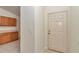 Hallway leading to a white front door, with a glimpse of kitchen cabinets on the left at 15711 Sw 52Nd Avenue Rd, Ocala, FL 34473