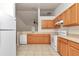 Functional kitchen with matching appliances, wooden cabinets, and a breakfast bar at 15711 Sw 52Nd Avenue Rd, Ocala, FL 34473