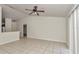 Well-lit living room featuring neutral walls, tile flooring, and glimpses into the kitchen at 15711 Sw 52Nd Avenue Rd, Ocala, FL 34473