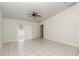 Spacious living room featuring tile floors, a ceiling fan, and access to the backyard through sliding glass doors at 15711 Sw 52Nd Avenue Rd, Ocala, FL 34473
