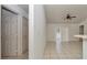 Open-concept living room with neutral-toned walls, tile flooring, a ceiling fan, and sliding glass doors at 15711 Sw 52Nd Avenue Rd, Ocala, FL 34473