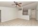 Bright living room with tile flooring and neutral walls, offering a view into the kitchen at 15711 Sw 52Nd Avenue Rd, Ocala, FL 34473