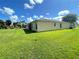 Spacious backyard with well-maintained green lawn, mature trees, and manicured landscaping, creating a peaceful outdoor retreat at 15822 Sw 16Th Avenue Rd, Ocala, FL 34473