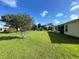 A well-maintained backyard featuring green grass, mature trees, and manicured landscaping, perfect for outdoor enjoyment at 15822 Sw 16Th Avenue Rd, Ocala, FL 34473