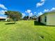 Expansive lawn with views of the community, mature trees, and clear blue sky at 15822 Sw 16Th Avenue Rd, Ocala, FL 34473