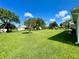 Lush backyard featuring a sprawling green lawn and mature trees offering shade and privacy at 15822 Sw 16Th Avenue Rd, Ocala, FL 34473