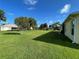 Large backyard with lush green lawn, mature trees, and manicured landscaping, ideal for relaxation and recreation at 15822 Sw 16Th Avenue Rd, Ocala, FL 34473