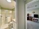 View through doorway to bathroom with glass enclosed shower and to office with desk at 15822 Sw 16Th Avenue Rd, Ocala, FL 34473