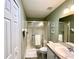 Bathroom featuring a glass enclosed shower, closet, sink, mirror and lighting at 15822 Sw 16Th Avenue Rd, Ocala, FL 34473