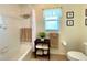 Bathroom showing a bathtub/shower combination, toilet, and linen storage at 15822 Sw 16Th Avenue Rd, Ocala, FL 34473
