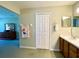 Bathroom features a single vanity with closet, towels and opens to main bedroom at 15822 Sw 16Th Avenue Rd, Ocala, FL 34473