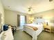 Comfortable bedroom with ceiling fan, white furniture, carpet and window at 15822 Sw 16Th Avenue Rd, Ocala, FL 34473