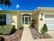 Close-up of a home's front entrance featuring a decorative glass door and manicured landscaping at 15822 Sw 16Th Avenue Rd, Ocala, FL 34473