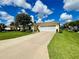 Charming home with a well-kept lawn, manicured shrubs, and an inviting driveway on a sunny day at 15822 Sw 16Th Avenue Rd, Ocala, FL 34473