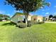 Well-maintained home exterior with lush lawn, mature landscaping, and a neatly manicured yard at 15822 Sw 16Th Avenue Rd, Ocala, FL 34473