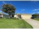Well-maintained home with lush green lawn, flowering tree, and attached garage at 15822 Sw 16Th Avenue Rd, Ocala, FL 34473