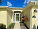 Charming home entrance with a screen door, beautiful flower baskets, and meticulous landscaping at 15822 Sw 16Th Avenue Rd, Ocala, FL 34473