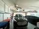 Spacious garage with a car, storage cabinets, ceiling fan and an automatic door at 15822 Sw 16Th Avenue Rd, Ocala, FL 34473