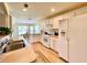Well-lit kitchen featuring white appliances, ample cabinet space, and a view to the breakfast nook at 15822 Sw 16Th Avenue Rd, Ocala, FL 34473