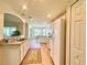 White kitchen with modern appliances, hardwood floors, and convenient access to storage at 15822 Sw 16Th Avenue Rd, Ocala, FL 34473