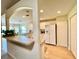 Open kitchen layout with breakfast bar, white appliances, and hardwood floors at 15822 Sw 16Th Avenue Rd, Ocala, FL 34473