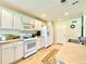 Well-lit kitchen with white cabinets, modern appliances, and ample counter space for meal preparation at 15822 Sw 16Th Avenue Rd, Ocala, FL 34473