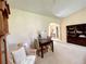 Comfortable living area with neutral carpet, a small table with chairs, and a view into the foyer at 15822 Sw 16Th Avenue Rd, Ocala, FL 34473