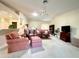 Open living space with vaulted ceilings, comfortable furniture, and a view into the kitchen area at 15822 Sw 16Th Avenue Rd, Ocala, FL 34473