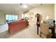 Cozy living room featuring a ceiling fan and connecting to the dining area and enclosed patio at 15822 Sw 16Th Avenue Rd, Ocala, FL 34473
