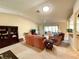 Cozy living room with comfortable seating, vaulted ceilings, and a view to the sunroom at 15822 Sw 16Th Avenue Rd, Ocala, FL 34473