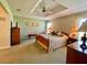 Relaxing main bedroom with tray ceiling, cozy furnishings, and natural light at 15822 Sw 16Th Avenue Rd, Ocala, FL 34473