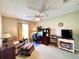 Home office with desk, chair, love seat, TV and ceiling fan at 15822 Sw 16Th Avenue Rd, Ocala, FL 34473
