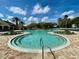 Resort-style pool area with inviting blue water, lounging chairs, and lush landscaping at 15822 Sw 16Th Avenue Rd, Ocala, FL 34473