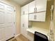 This storage area features cabinets, a closet, and a work space with direct access to the outside at 15822 Sw 16Th Avenue Rd, Ocala, FL 34473