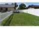 Fenced backyard with grass, white picket fence and chain link fence at 2201 Ne 45Th St, Ocala, FL 34479