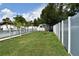 The backyard features lush greenery, a white picket fence, and a charming shed at 2201 Ne 45Th St, Ocala, FL 34479
